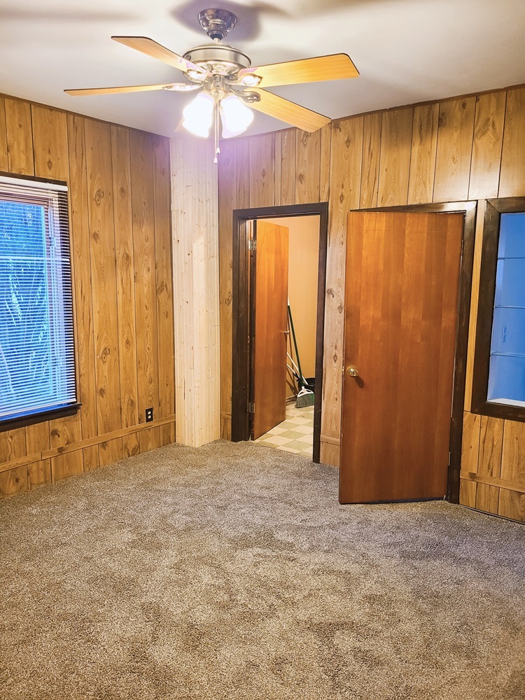 902 West 5th Street Sterling, IL 61081 - Photo 10 of 20 a view of a room with closet and a chandelier fan