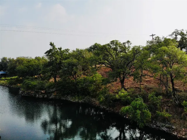 a view of a lake in middle of forest