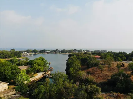 wooden floor with a view of residential house and lake