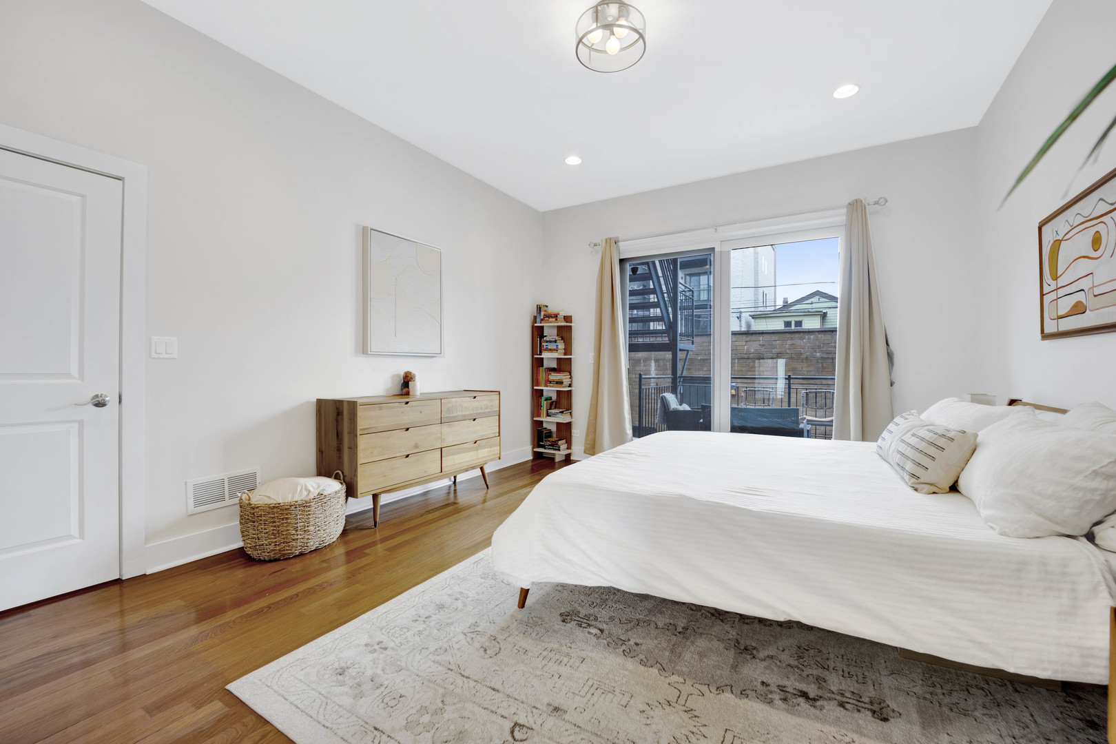1531 West Fry Street, Unit 1 Chicago, IL 60642 - Photo 11 of 25 a bedroom with a bed and wooden floor