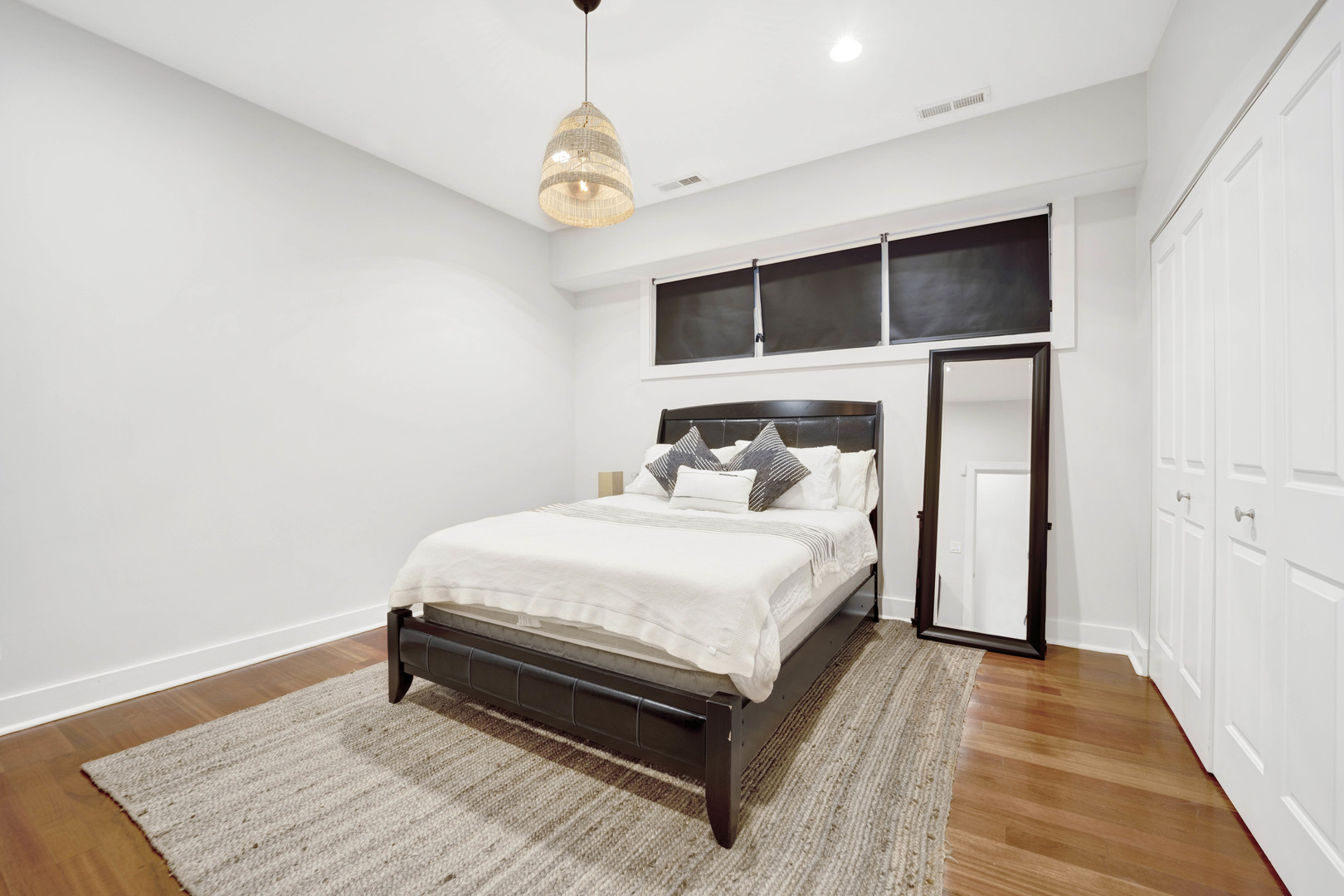 1531 West Fry Street, Unit 1 Chicago, IL 60642 - Photo 21 of 25 a bedroom with a bed and wooden floor