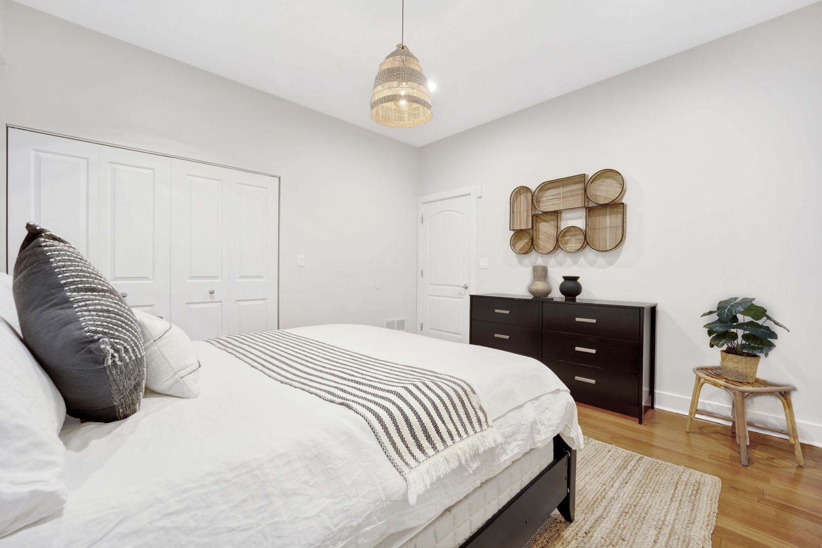 1531 West Fry Street, Unit 1 Chicago, IL 60642 - Photo 22 of 25 a bedroom with a bed and wooden floor