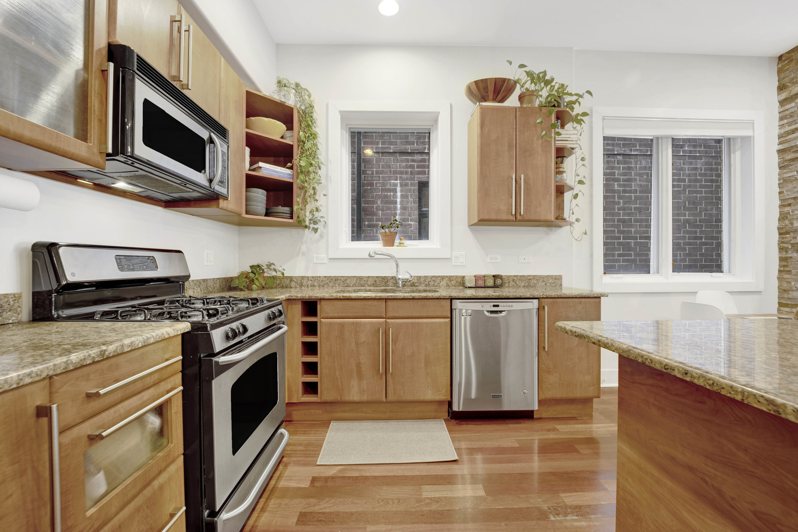 1531 West Fry Street, Unit 1 Chicago, IL 60642 - Photo 6 of 25 a kitchen with stainless steel appliances granite countertop a stove and a sink