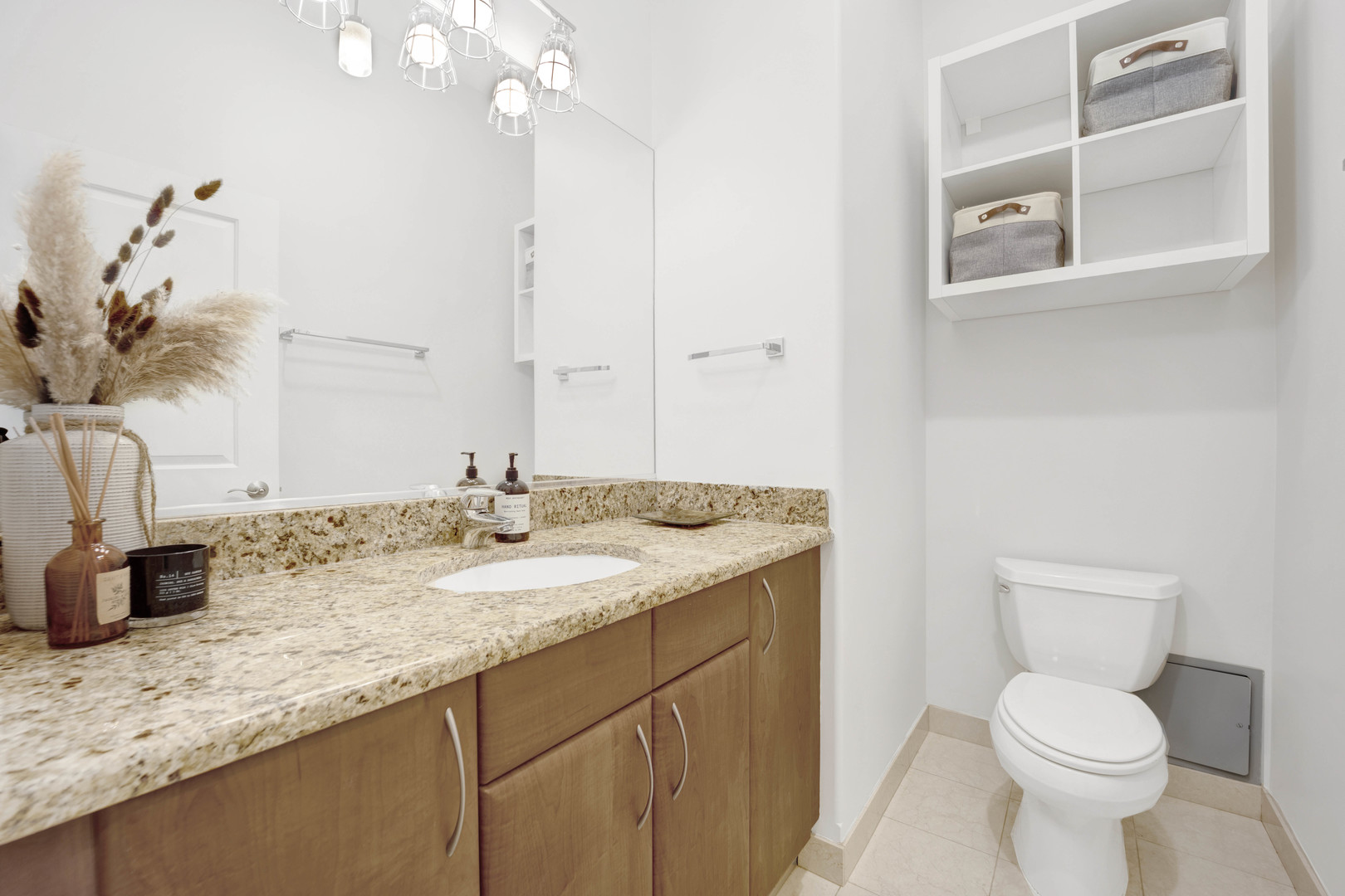1531 West Fry Street, Unit 1 Chicago, IL 60642 - Photo 9 of 25 a bathroom with a granite countertop sink a toilet and a mirror