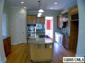 3276 Millstone Creek Road Lancaster, SC 29720 - Photo 6 of 8 a kitchen with stainless steel appliances granite countertop a refrigerator a stove and a wooden floors