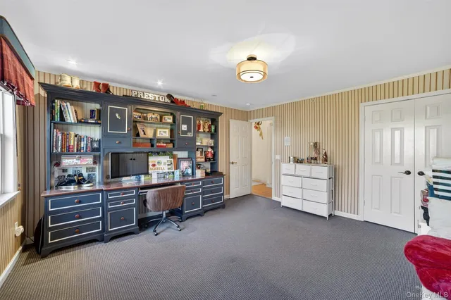 a bedroom with bed cabinet and window