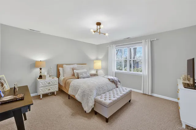 a bedroom with a bed and a lamp on table