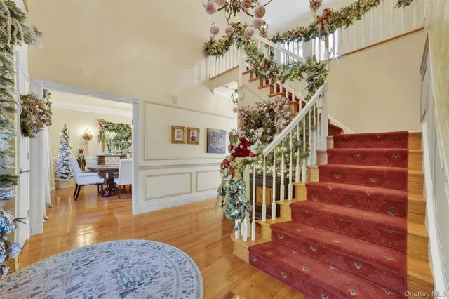 a view of entryway and hall with wooden floor