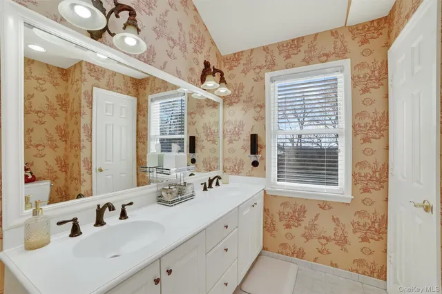 a bathroom with a tub shower and sink