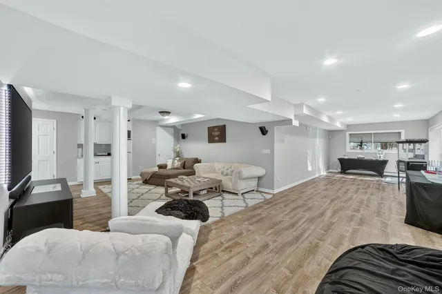 a white toilet sitting next to a bathroom sink and a mirror