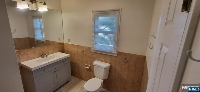 a bathroom with a toilet sink and mirror