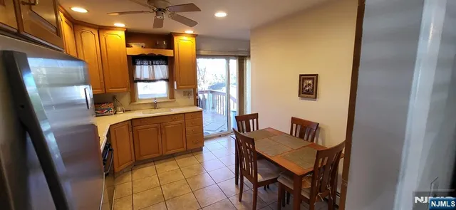 a kitchen with stainless steel appliances granite countertop sink refrigerator and microwave