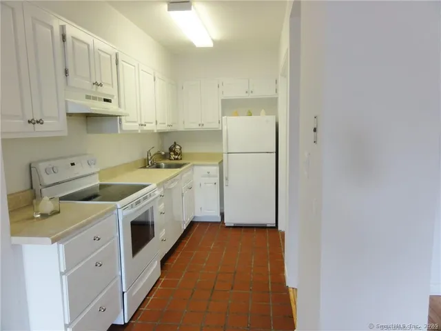 a utility room with cabinets washer and dryer