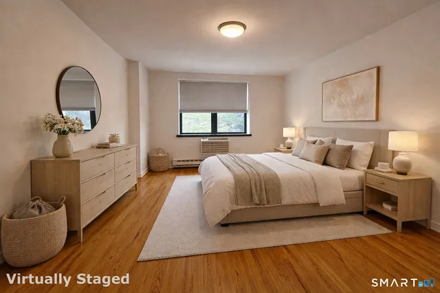 a spacious bedroom with a bed and a dresser