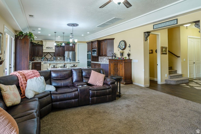 3683 South 2640 West St. George, UT 84790 - Photo 20 of 41 Open concept living area with carpeting and wood-finish flooring