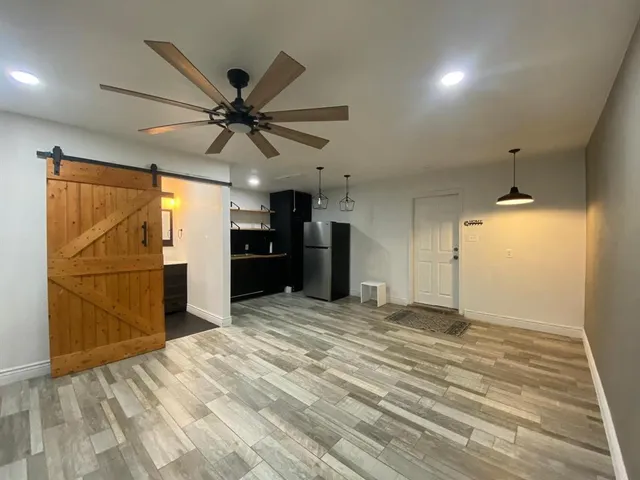 a view of a kitchen with a sink and a refrigerator