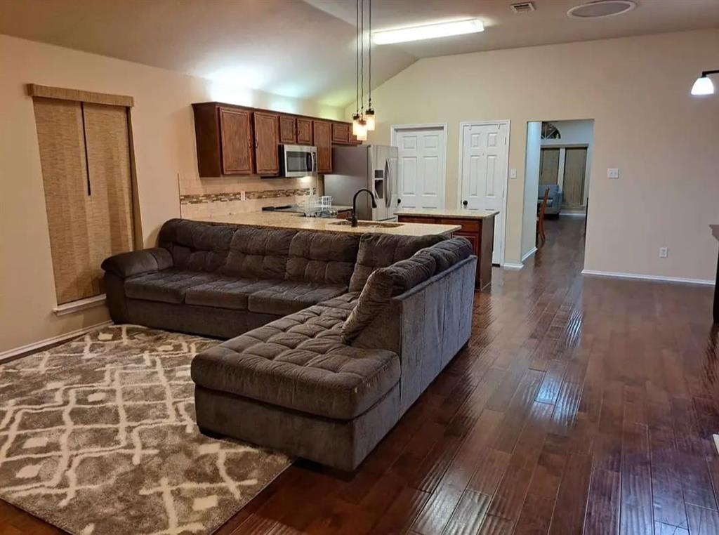 5326 Creek Court Garland, TX 75043 - Photo 5 of 6 a living room with furniture and a wooden floor