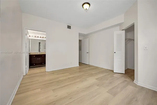 a view of a livingroom with wooden floor and a window