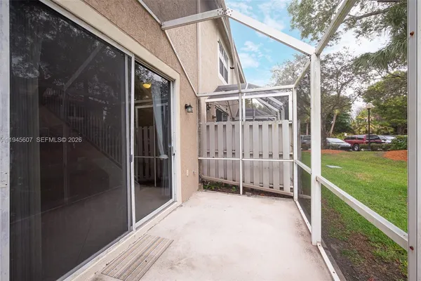 a view of a house with a big yard and large trees