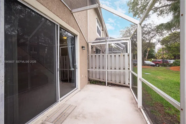 a view of a house with a big yard and large trees