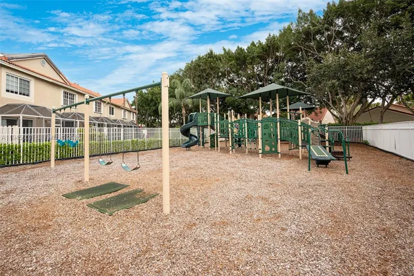 a view of a street with a yard and a large trees