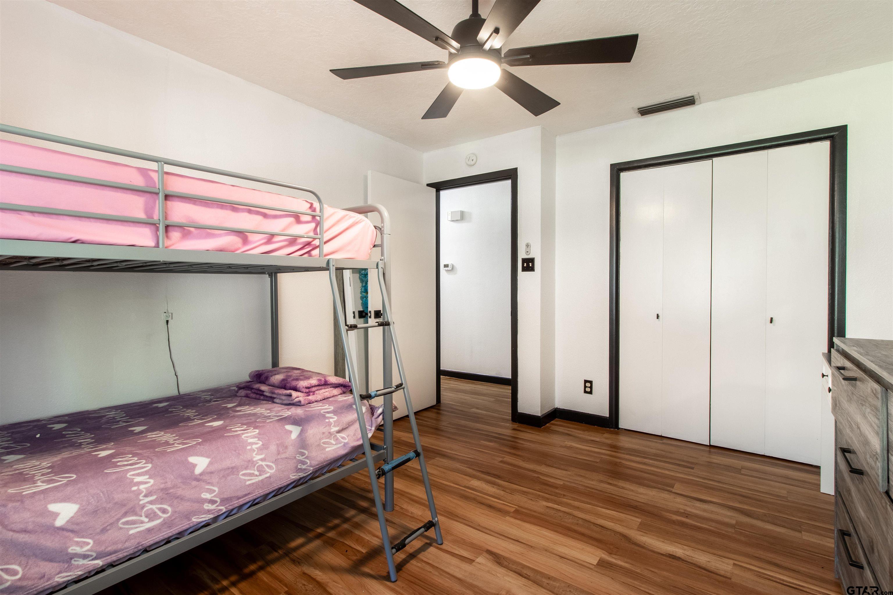 513 Lance Road Quitman, TX 75783 - Photo 15 of 27 a bedroom with a bed and a ceiling fan