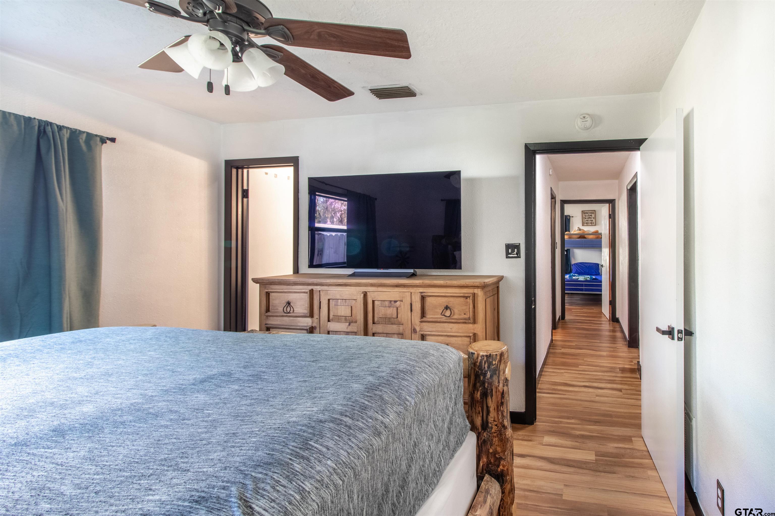 513 Lance Road Quitman, TX 75783 - Photo 17 of 27 a bedroom with a bed and a flat screen tv