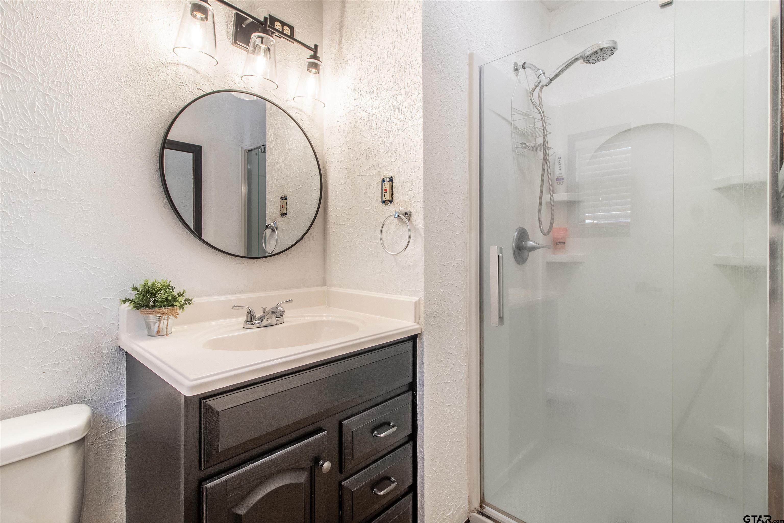 513 Lance Road Quitman, TX 75783 - Photo 18 of 27 a bathroom with a sink vanity mirror and toilet