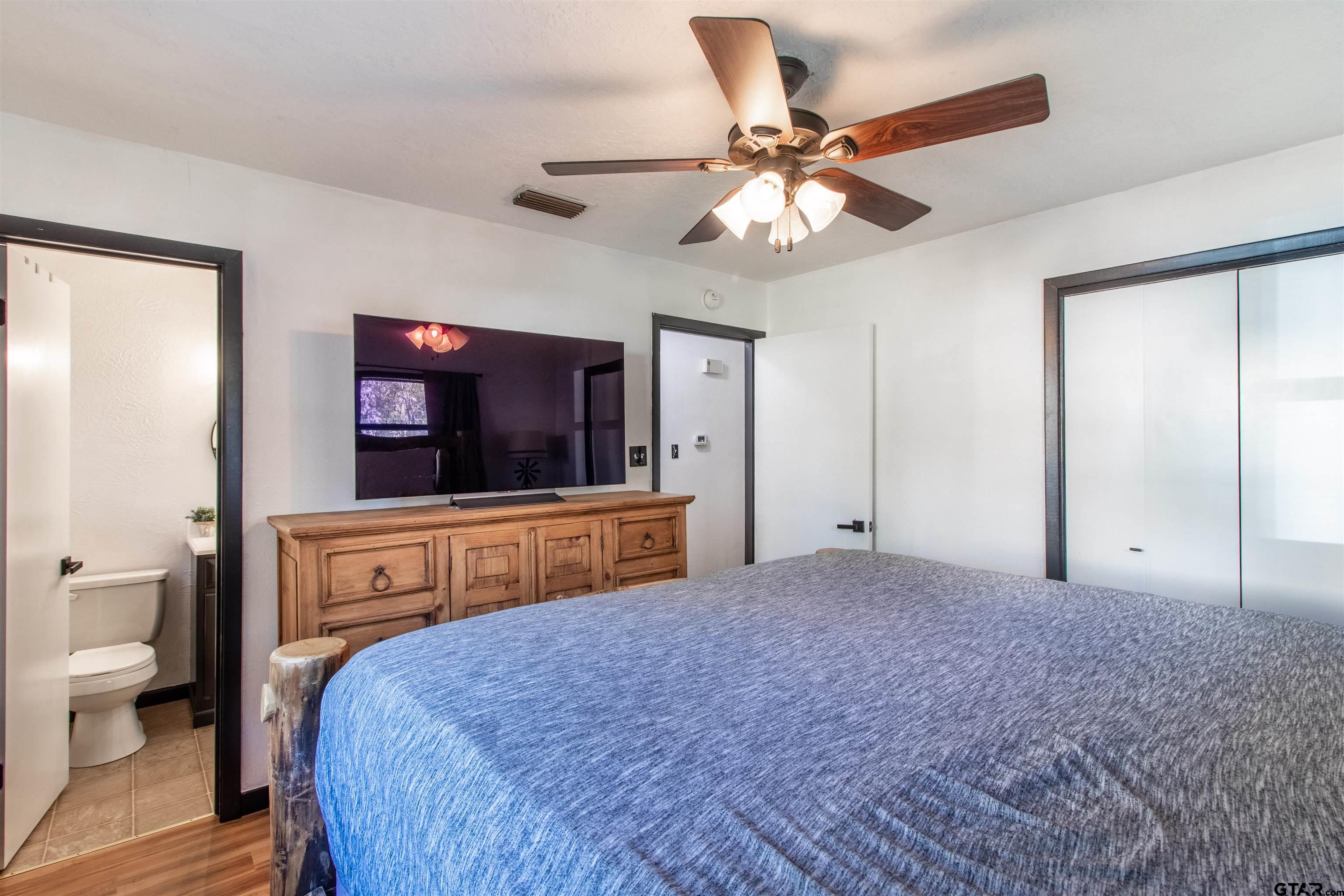513 Lance Road Quitman, TX 75783 - Photo 19 of 27 a bedroom with a bed and a flat screen tv