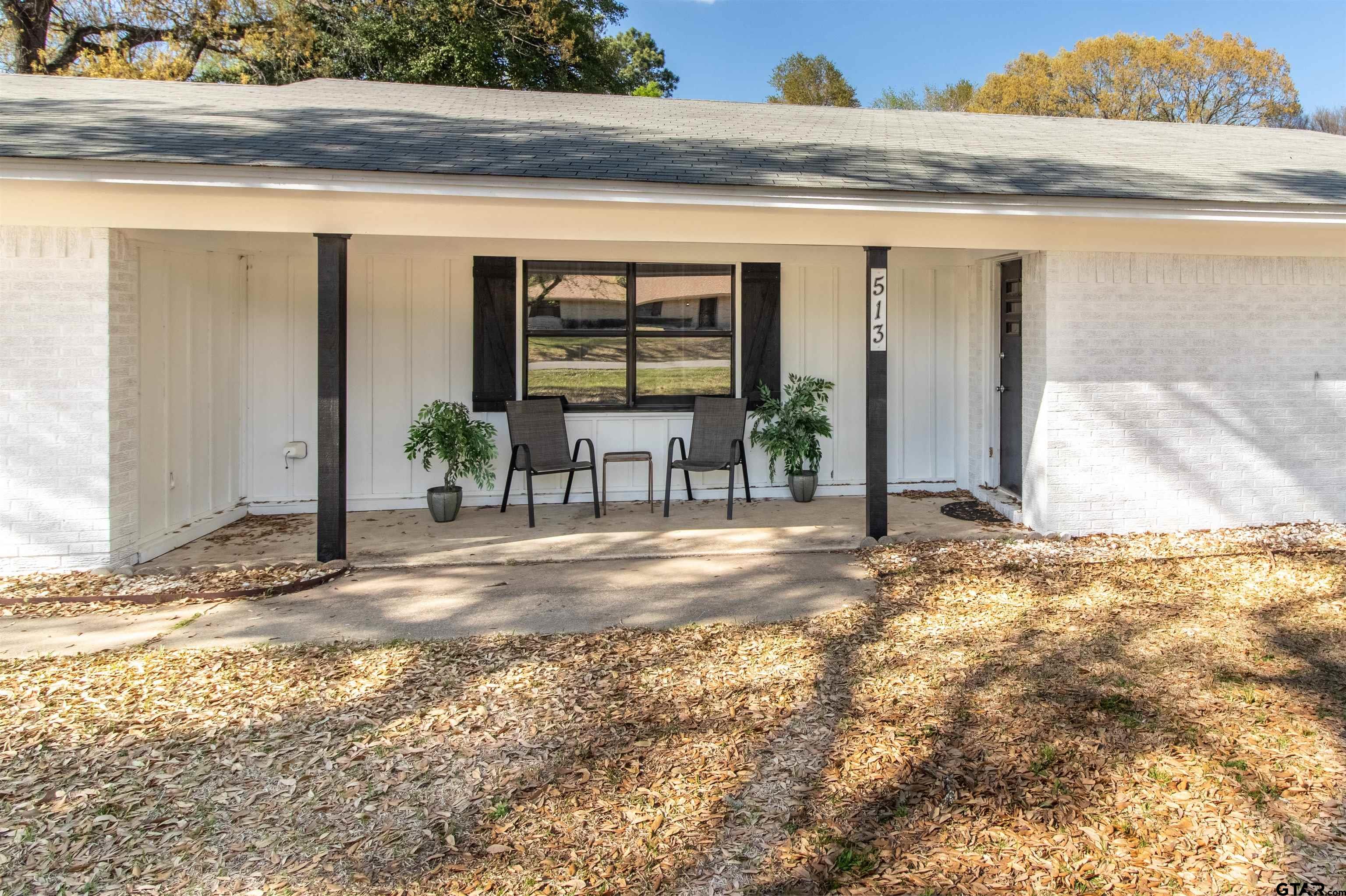 513 Lance Road Quitman, TX 75783 - Photo 2 of 27 a view of a house with backyard porch and seating space
