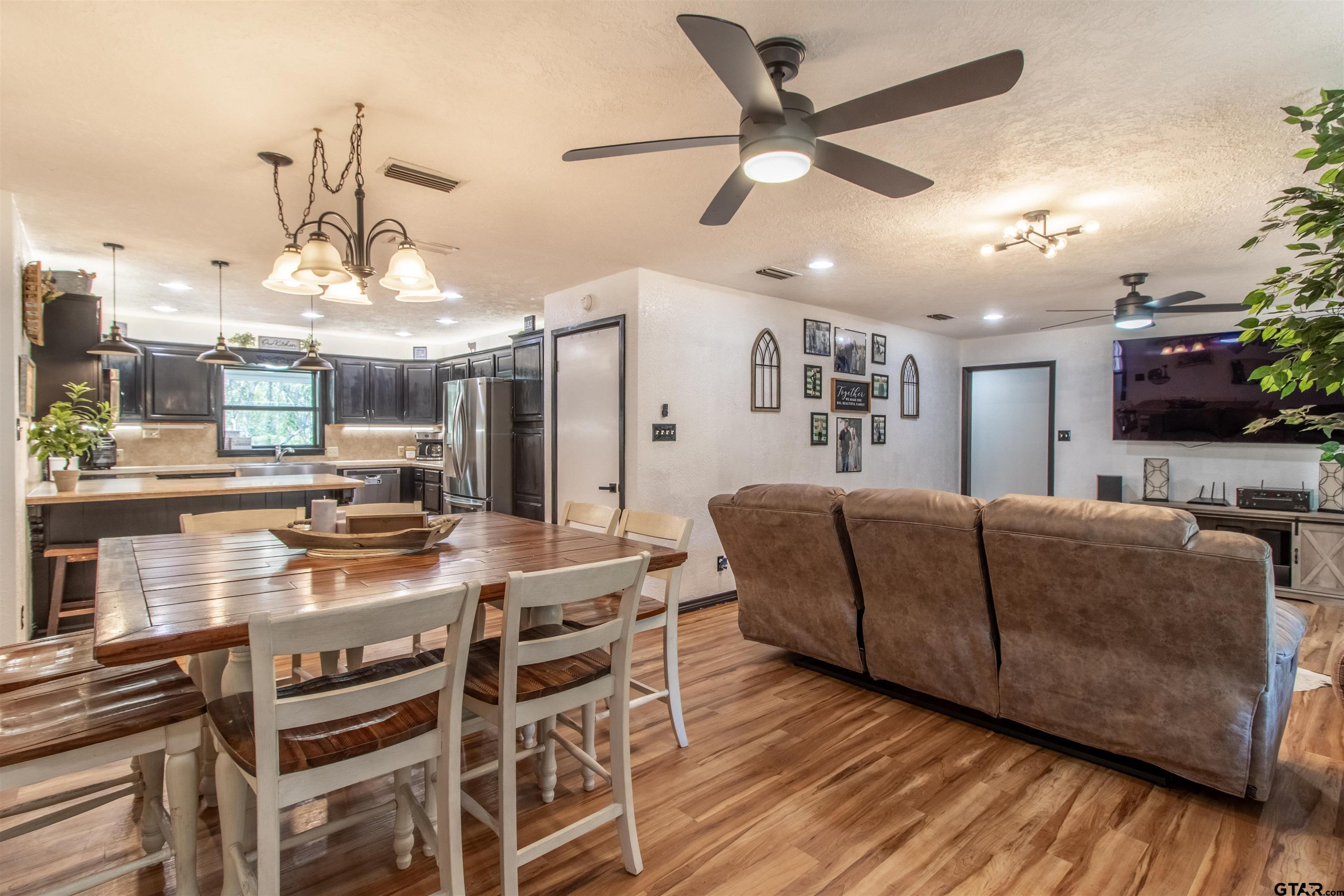 513 Lance Road Quitman, TX 75783 - Photo 5 of 27 a living room with furniture kitchen view and a chandelier