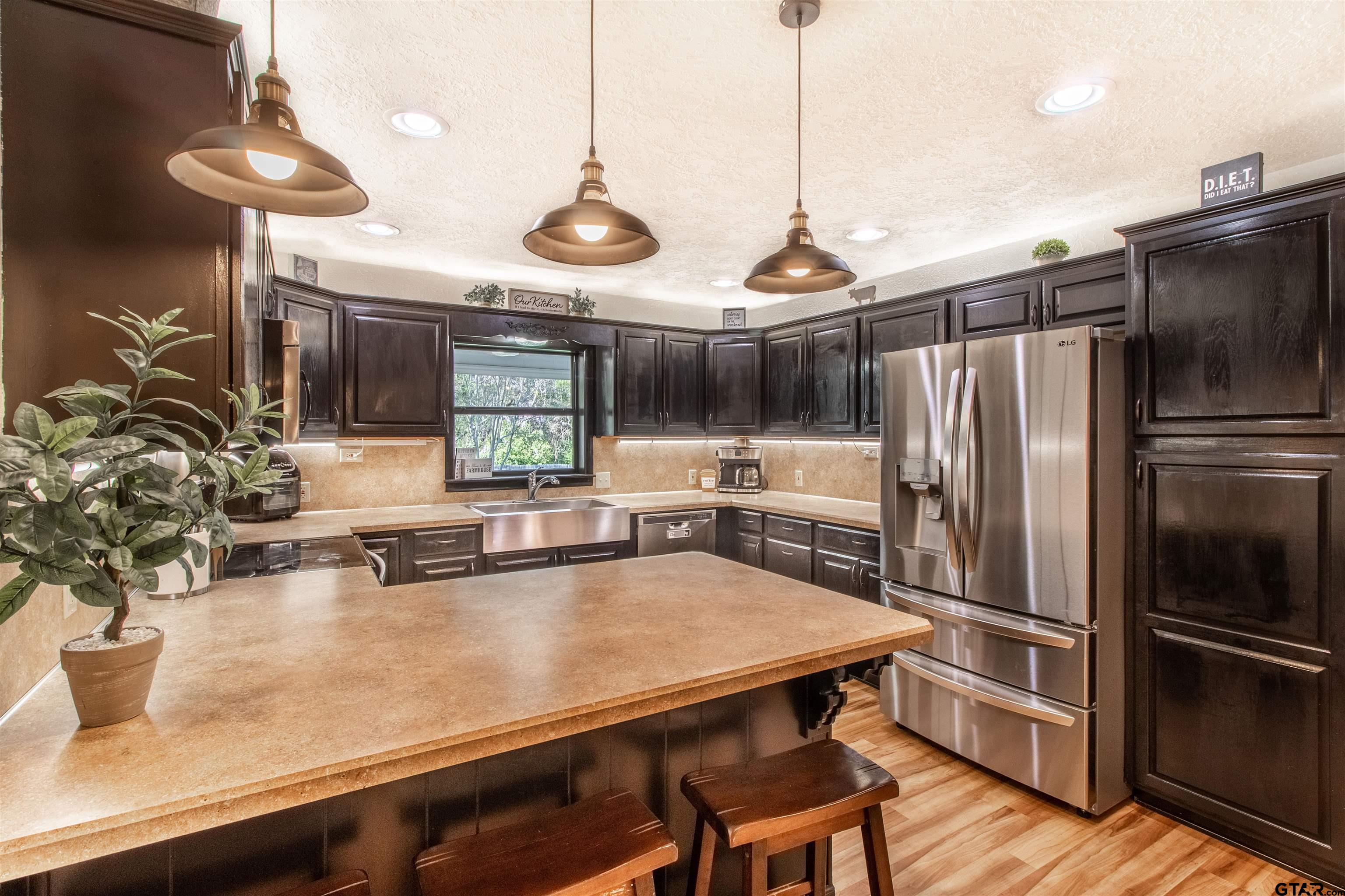 513 Lance Road Quitman, TX 75783 - Photo 7 of 27 a kitchen with kitchen island a counter space and stainless steel appliances