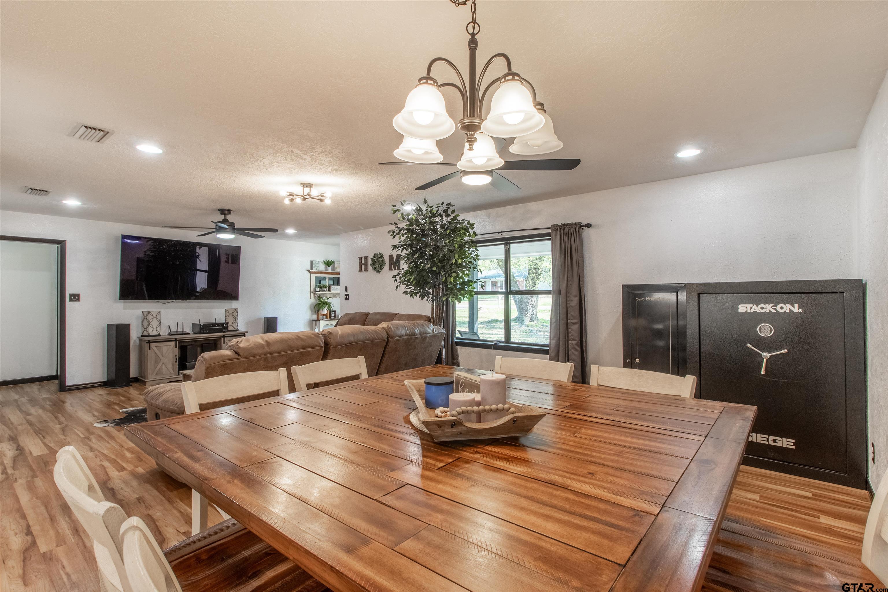 513 Lance Road Quitman, TX 75783 - Photo 8 of 27 a living room with furniture a flat screen tv and kitchen view