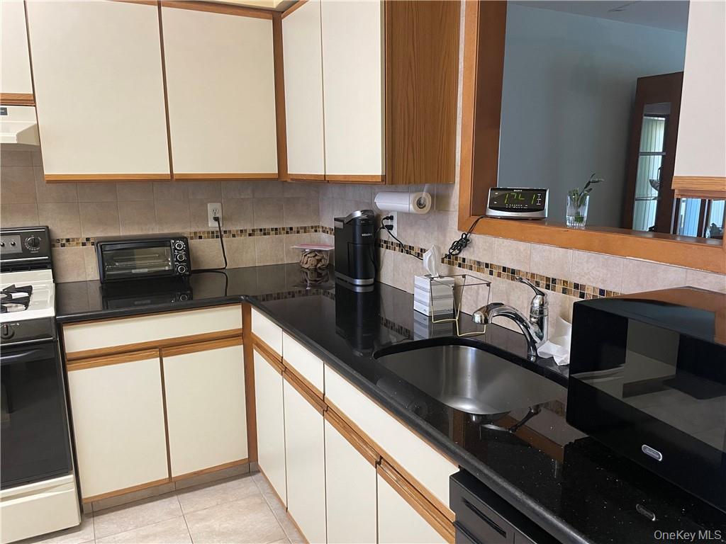 135 West Nyack Road, Unit 93 Nanuet, NY 10954 - Photo 4 of 12 a kitchen with stainless steel appliances granite countertop a sink and a stove