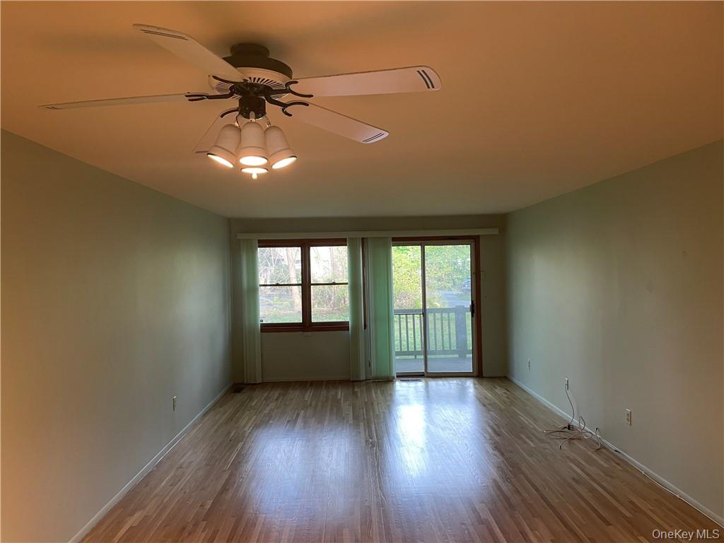 135 West Nyack Road, Unit 93 Nanuet, NY 10954 - Photo 6 of 12 an empty room with wooden floor and windows