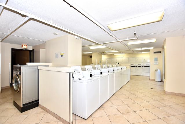 a view of a patio with a table and chairs and potted plants