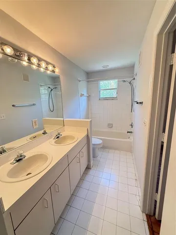 a bathroom with a double vanity sink mirror and double