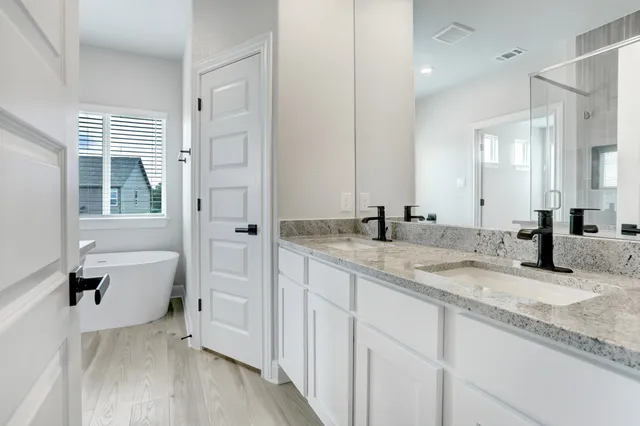 a bathroom with a granite countertop sink mirror and toilet