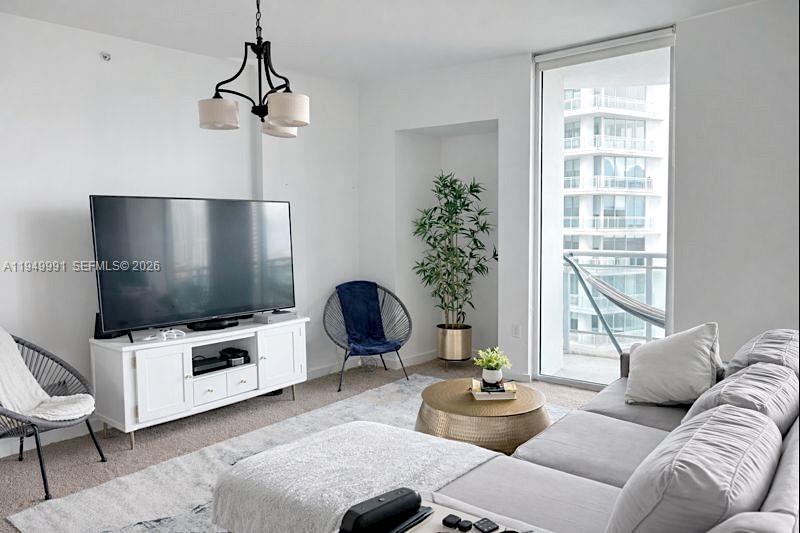 350 South Miami Avenue, Unit 2215 Miami, FL 33130 - Photo 3 of 20 a living room with furniture and a flat screen tv