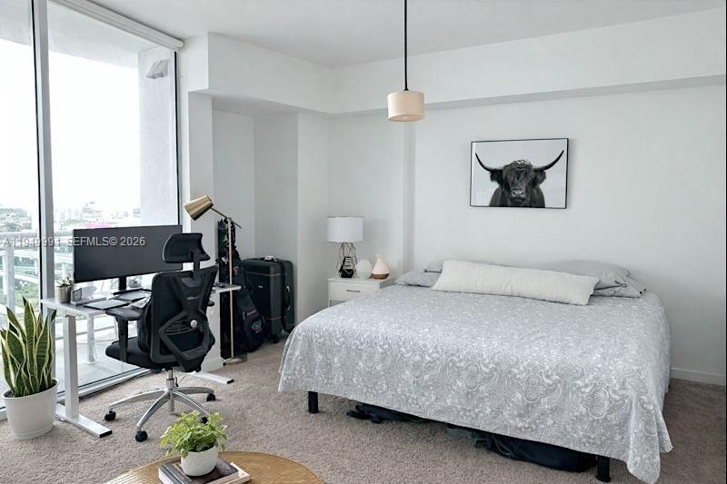 350 South Miami Avenue, Unit 2215 Miami, FL 33130 - Photo 5 of 20 a bedroom with a bed and dresser