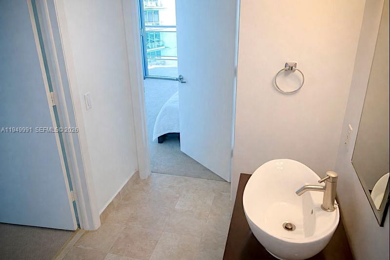 350 South Miami Avenue, Unit 2215 Miami, FL 33130 - Photo 7 of 20 a view of a hallway with washer and dryer