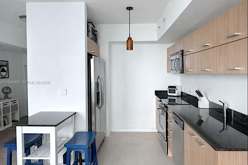 350 South Miami Avenue, Unit 2215 Miami, FL 33130 - Photo 9 of 20 a kitchen with a sink a stove a refrigerator and cabinets