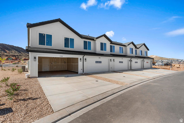 2194 Wolverine Way, Unit 2531 Washington, UT 84780 - Photo 4 of 52 Contemporary townhome exteriors featuring white stucco, black trim, and dark roofing