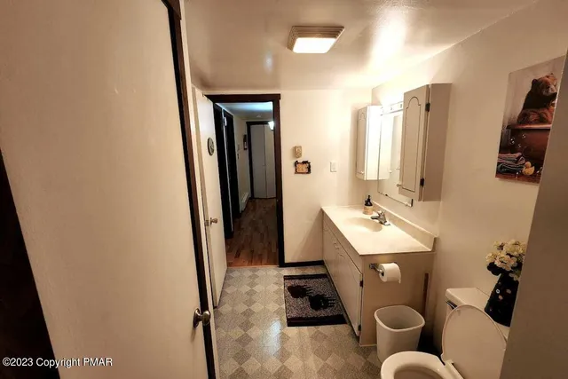 a bathroom with sink mirror vanity and toilet