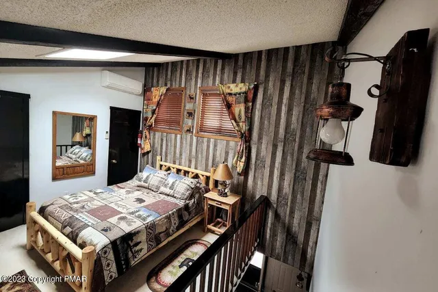 a bed sitting in a bedroom next to a window