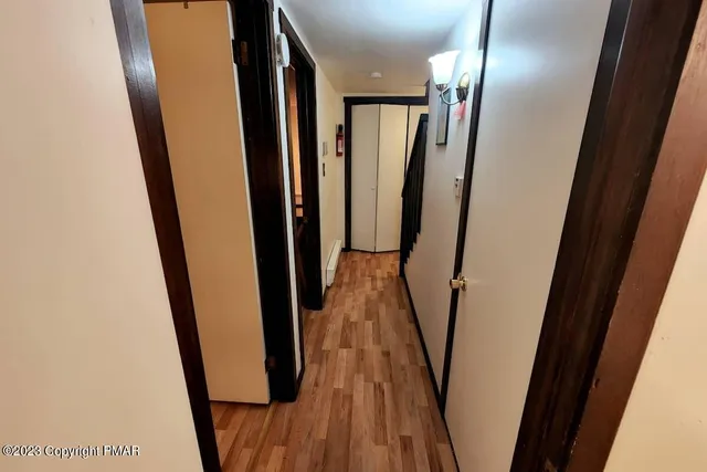 a view of hallway with wooden floor