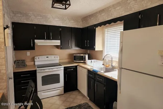 a kitchen with a stove and a refrigerator
