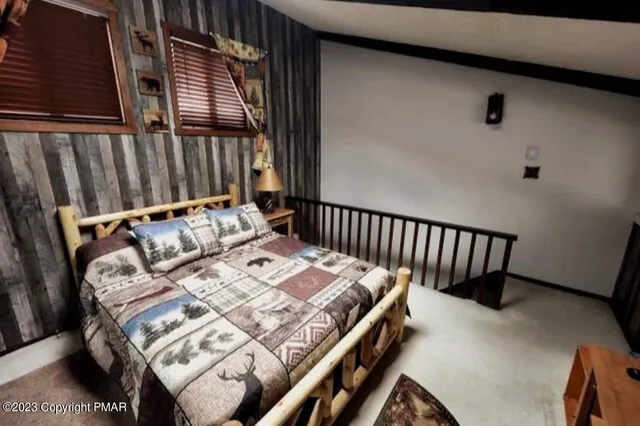 a bed sitting in a bedroom next to a window