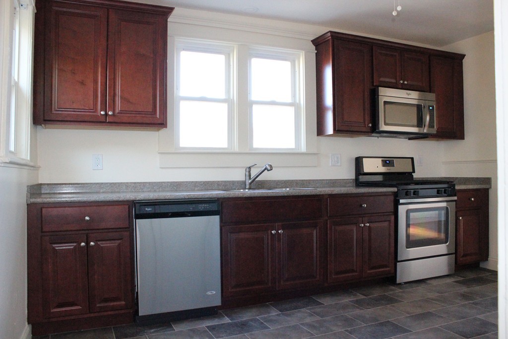 463 Boston Road Billerica, MA 01821 - Photo 6 of 19 a kitchen with stainless steel appliances granite countertop a sink and a microwave