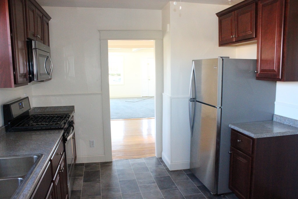 463 Boston Road Billerica, MA 01821 - Photo 8 of 19 a kitchen with a refrigerator and a sink
